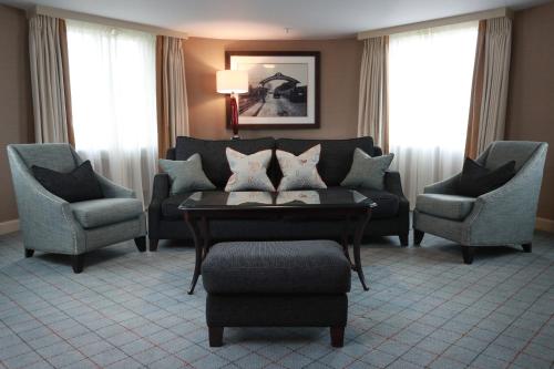 a living room filled with furniture and a large window at Dalmahoy Hotel & Country Club in Edinburgh