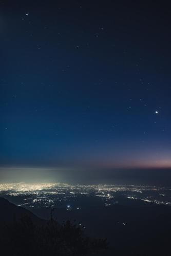 a view of the city at night from a mountain at Everest Base Camp, Near George Everest House, 5kms from Library chowk in Mussoorie