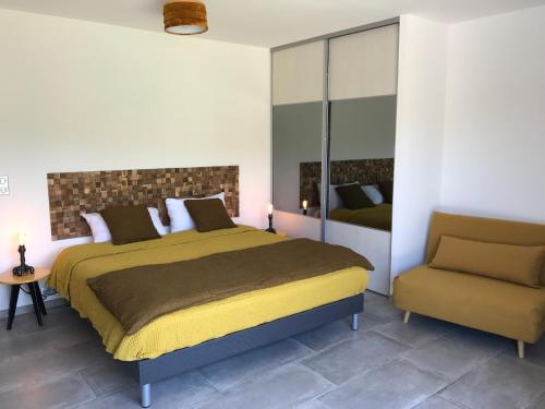 a bedroom with a large bed and a chair at villa rocca in Sotta