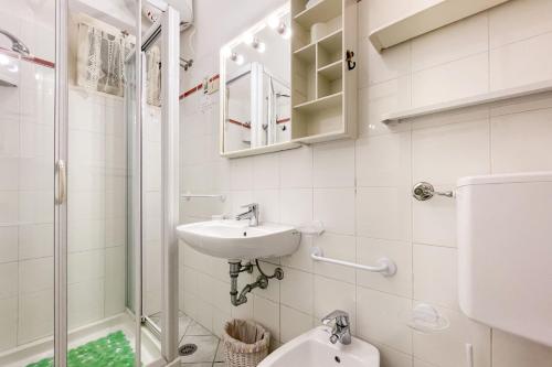 a bathroom with a sink and a toilet and a shower at Appartamento La Vacanza in Rio nellʼElba