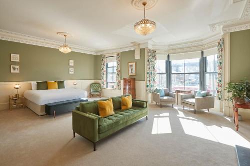 a bedroom with a bed and a green couch at Host & Stay - Milton Street Apartments in Saltburn-by-the-Sea