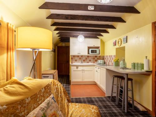 a kitchen with a couch and a table in a room at Holiday Home Deveron Valley Cottages by Interhome in Marnoch