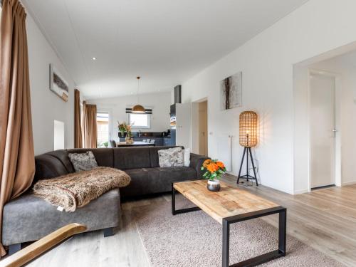 a living room with a couch and a coffee table at Holiday Home Green Resort Mooi Bemelen by Interhome in Bemelen