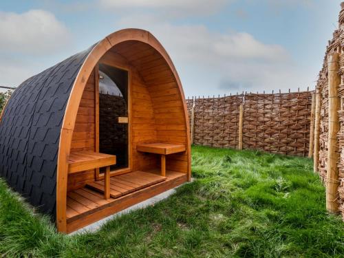 a tire shaped iguana house in the grass at Holiday Home Green Resort Mooi Bemelen by Interhome in Bemelen