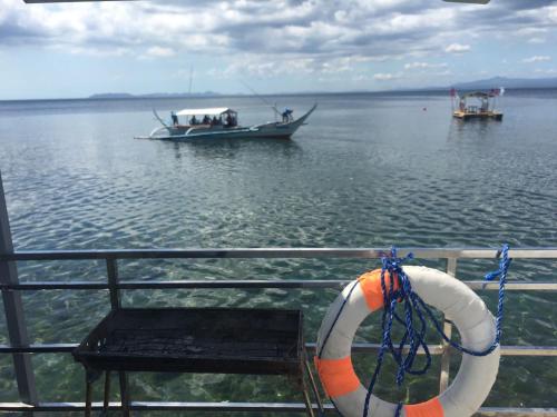 a boat on a body of water with a life preserver at The Philip Ann Resort in Mabini