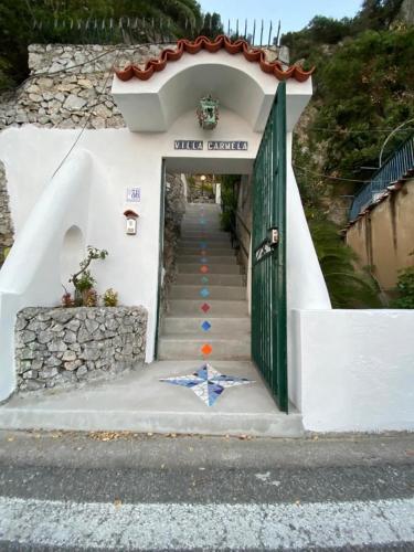 a stairway leading to a building with a green door at Villa Carmela in Conca dei Marini