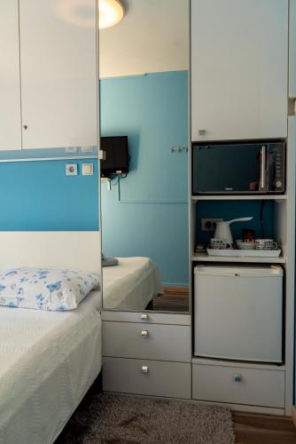 a bedroom with a mirror next to a bed at Apartments & Rooms Andrea 2 in Zadar