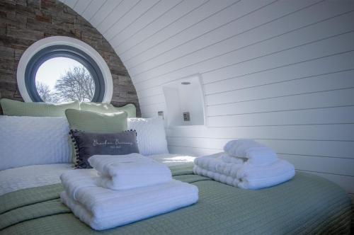 a bedroom with two pillows on a bed with a window at Bracken Burrows - 1 Bedroom Pod - New Hedges in New Hedges