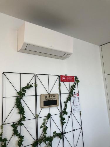 a sign on a wall with plants on it at Casa das Falcoeiras - AL com vista Ria in Aveiro