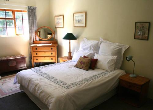 a bedroom with a large bed with white sheets and pillows at 34 Steyn Street, Barrydale in Barrydale
