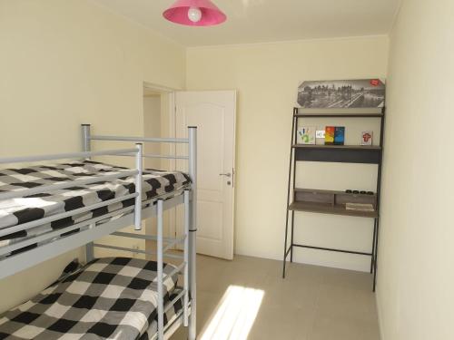 a bedroom with a bunk bed and a shelf at University Apartment in Baia Mare