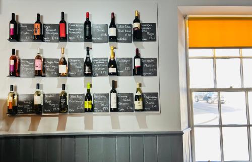 a bunch of bottles of wine on a wall at Cove Bay Hotel in Aberdeen