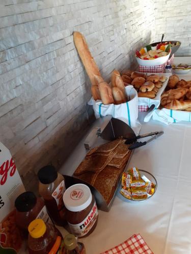 a table with a bunch of bread and other foods at Peace & Love Hostel in Paris