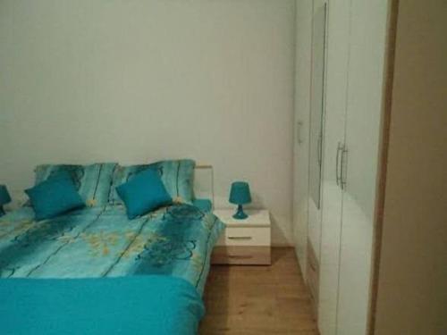 a bedroom with a blue bed and a night stand at Ugljanski gusari in Ugljan