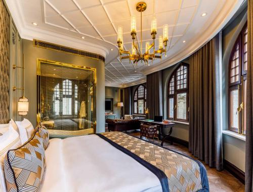 a bedroom with a king sized bed and a desk at Cronton Design Hotel in Istanbul