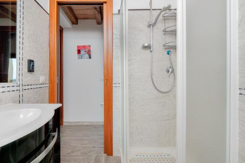 a bathroom with a shower and a sink at La finestra sul mare in Budoni