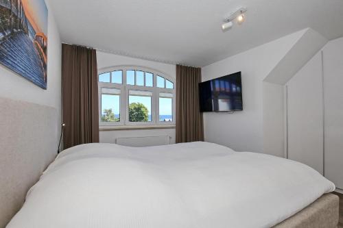 En eller flere senge i et værelse på Villa Hanse Wohnung 319