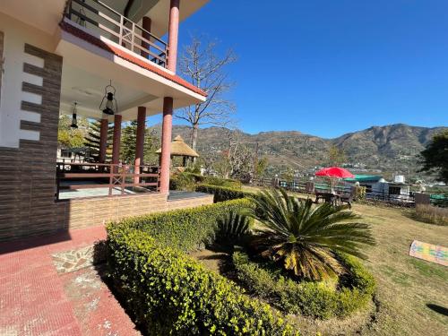 a house with a view of the mountains at Sangita Resorts in Nainital