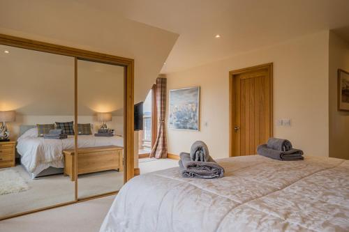 a bedroom with a large bed and a mirror at Waterloo House in Lochinver