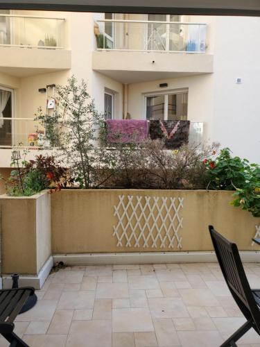 a balcony of a building with chairs and plants at Le Pin Doré in Antibes