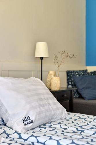 a bed with a pillow on top of it at Kurort Stara Wędzarnia in Gdańsk
