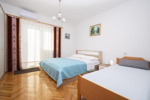 Posteľ alebo postele v izbe v ubytovaní Apartment Monika