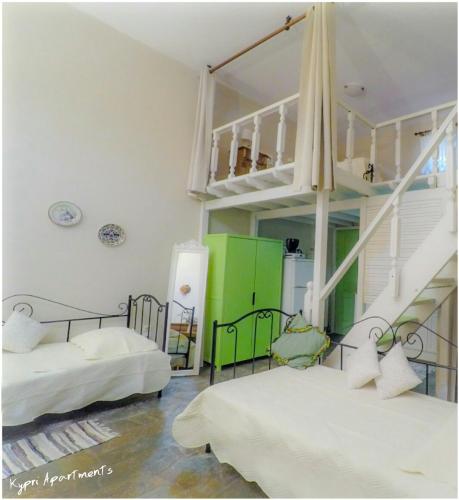 a room with two beds and a staircase at Kypri Apartments in Kipri