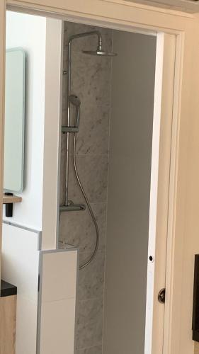 a shower in a bathroom with a glass door at L'Hostellerie d'Acquigny in Acquigny