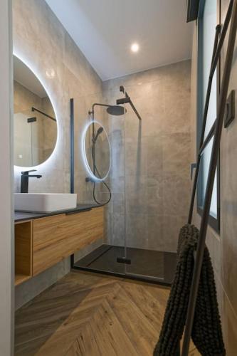 une salle de bain avec une douche, un lavabo et un miroir dans l'établissement Appartement d’exception en centre ville sur quai, à Sète
