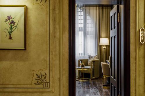 a hallway with a room with a chair and a table at Cronton Design Hotel in Istanbul