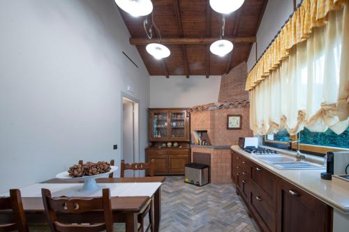 a large kitchen with a table and a counter top at Villa Arianna Acireale in Acireale