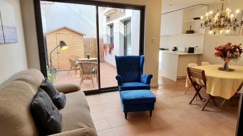 a living room with a couch and a table at Opening Doors Vilassar. Family house Beach & Relax in Vilassar de Mar