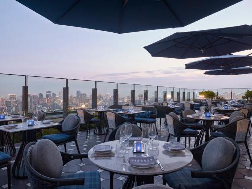 a restaurant with tables and chairs and umbrellas at Four Seasons Hotel Tokyo at Otemachi in Tokyo