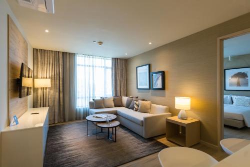 a living room with a couch and a table at Somerset Westview Nairobi in Nairobi