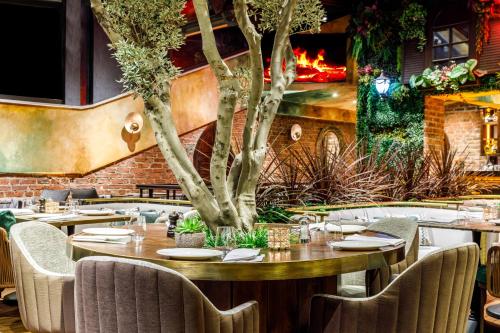a restaurant with tables and chairs and a fireplace at Cronton Design Hotel in Istanbul