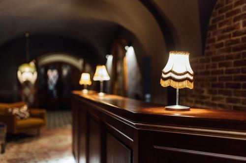 a table with two lamps on top of it at Nana Macs in Prague