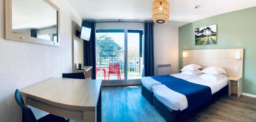 a hotel room with a bed and a table at Hippotel in Le Touquet-Paris-Plage