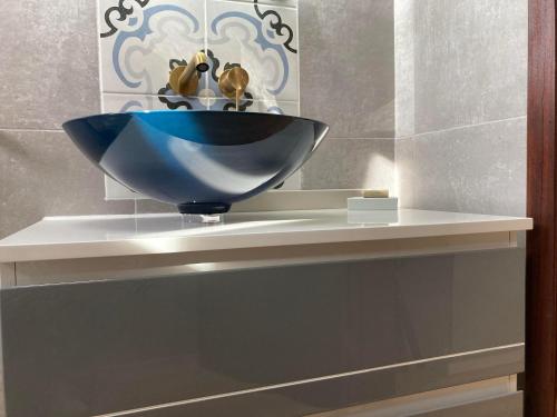 a blue bowl on a shelf in a bathroom at Quinta da Luz - A Luxury Boutique B&B in Silves