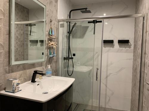 a bathroom with a sink and a shower at Funchal Apt- Sleeps 2 - Pool & Garden - Madeira in Funchal