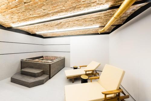 a room with two chairs and a fireplace at TRIBE Riga City Centre in Rīga