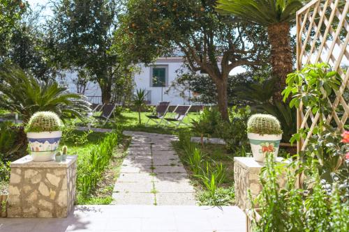 a garden with two potted plants and a pathway at Villa Caterina b&b in Procida