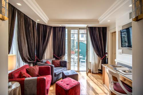 a living room with two couches and a window at The Britannia Hotel in Rome