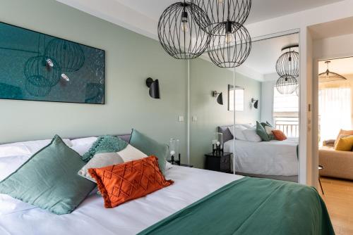 - une chambre avec deux lits et deux lustres dans l'établissement Cours Morny, à Deauville