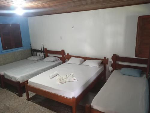 Giường trong phòng chung tại Pousada Asa Branca