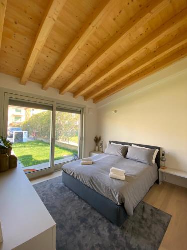 a bedroom with a bed and a large window at Little Mier in Iseo