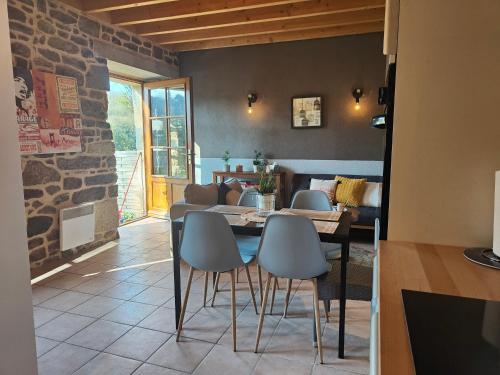 a kitchen and dining room with a table and chairs at La Tannerie du Port in Dinan