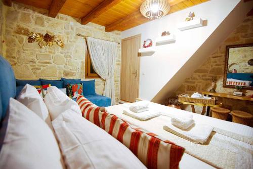 a bedroom with two beds in a room at Stonehouse Olivelia - Afrathias Beach in Tympáki