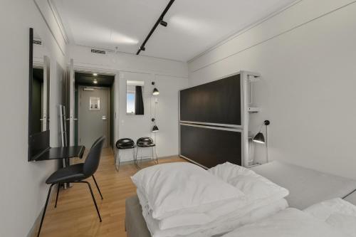 a bedroom with a bed and a desk and a chair at Danhostel Copenhagen City in Copenhagen