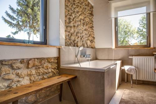 a bathroom with a sink and a stone wall at Winzarei Ciringa Menhard in Zgornja Kungota