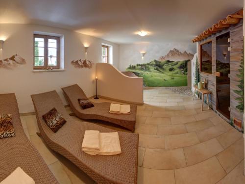 a living room with couches and a painting on the wall at Feriendomizil Stöberl - Chiemgau Karte in Inzell